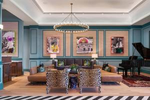 a living room with a couch and a table at The Memphian a Tribute Portfolio Hotel in Memphis