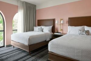 a hotel room with two beds and a window at The Memphian a Tribute Portfolio Hotel in Memphis