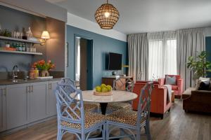 a kitchen and living room with a table and chairs at The Memphian a Tribute Portfolio Hotel in Memphis