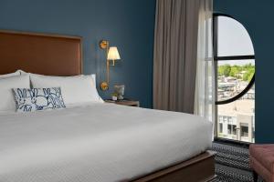 a bedroom with a large bed and a large window at The Memphian a Tribute Portfolio Hotel in Memphis