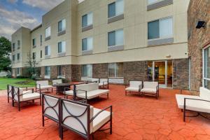 a patio with chairs and tables in front of a building at Fairfield Inn by Marriott Las Colinas in Irving