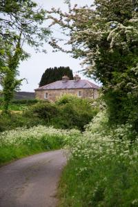 an old house on the side of a dirt road at Prizon House Balla in Mayo