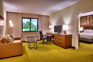 a hotel room with a bed and a desk at Courtyard by Marriott Oahu North Shore in Laie
