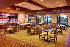 a restaurant with tables and chairs and a bar at Courtyard by Marriott Oahu North Shore in Laie