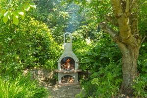 a fireplace in the middle of a garden at Luccombe Villa Holiday Apartments in Shanklin