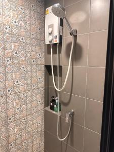 a shower with a shower head in a bathroom at Deluxe Pool View La Casita Hua Hin Managed By Asiabb in Hua Hin