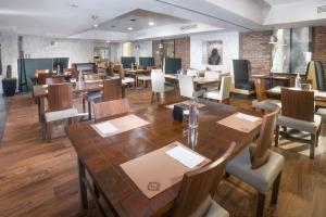 a dining room with wooden tables and chairs at Four Points by Sheraton Saltillo in Saltillo