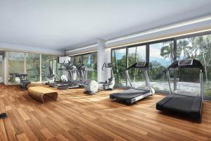 a gym with a bunch of exercise equipment in a room at Sheraton Belitung Resort in Tanjungbinga