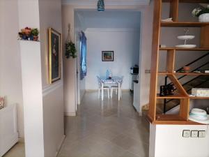 a hallway with a table and a dining room at Maison Belle Dune in Saïdia
