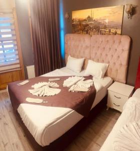 a bedroom with a large bed with towels on it at Old City Family Hotel in Istanbul