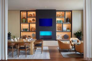 a dining room with a table and a tv at Bellyard, West Midtown Atlanta, a Tribute Portfolio Hotel in Atlanta