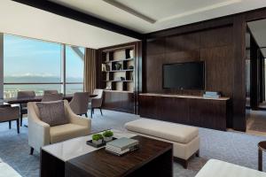 a living room with a tv and a couch and a table at JW Marriott Hotel Yinchuan in Yinchuan