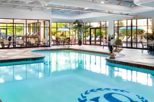 a swimming pool with tables and chairs in a building at Sheraton Pittsburgh Hotel at Station Square in Pittsburgh