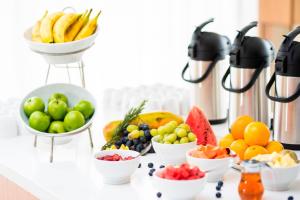 a table topped with bowls of fruits and vegetables at AC Hotels by Marriott Guatemala City in Guatemala