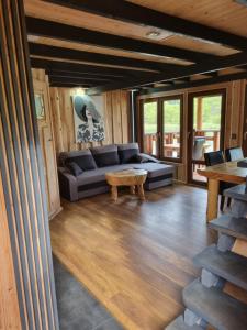 a living room with a couch and a table at Domki nad Sanem in Lesko