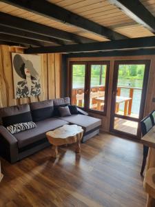 a living room with a couch and a table at Domki nad Sanem in Lesko