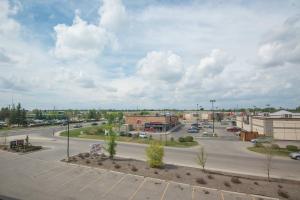 an empty parking lot with a street in a town at Four Points by Sheraton Saskatoon in Saskatoon