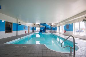 a swimming pool with a slide in a building at Four Points by Sheraton Saskatoon in Saskatoon