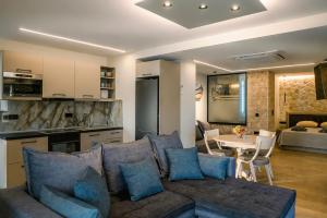 a living room with a couch and a table at Black Rocks Luxury Seafront Beach Suite in Agios Gordios