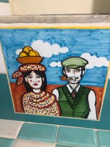a painting of a man and a woman on a wall at Maison al Duomo in Messina
