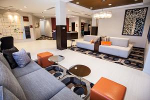 a lobby with two couches and a table at TownePlace Suites by Marriott Boynton Beach in Boynton Beach