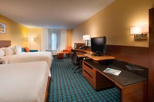 a hotel room with two beds and a desk with a television at Fairfield Inn and Suites by Marriott Tifton in Tifton