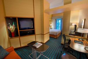 a hotel room with a bed and a desk and a room at Fairfield Inn and Suites by Marriott Tifton in Tifton