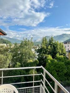 a balcony with a view of trees and mountains at Lourdes Home in Lourdes