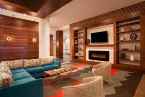 a living room with a blue couch and a fireplace at Four Points by Sheraton Richmond in Midlothian