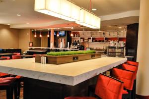 a bar in a restaurant with red chairs at Courtyard Salina in Salina