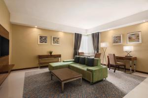 a living room with a couch and a table at Howard Johnson by Wyndham Abu Dhabi Downtown in Abu Dhabi