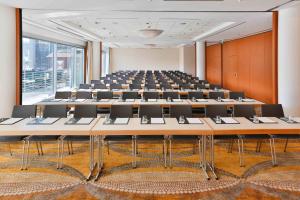 a large room with rows of tables and chairs at Courtyard by Marriott Duesseldorf Hafen in Düsseldorf
