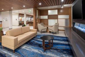a living room with a couch and a table at Fairfield by Marriott Inn & Suites Anaheim Los Alamitos in Los Alamitos