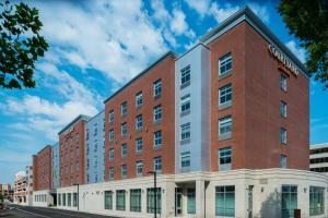 a large red brick building on a city street at Courtyard by Marriott Edgewater NYC Area in Edgewater