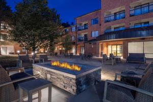 a patio with a fire pit in front of a building at Courtyard by Marriott Boulder Broomfield in Louisville