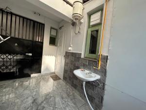 a bathroom with a sink and a window at Cozy Nest - Garden Facing Apartment with Kitchen in Chandīgarh