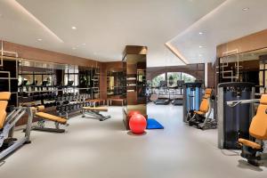 a gym with a lot of treadmills and machines at Four Points by Sheraton Makkah Al Naseem in Mecca