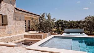 a swimming pool in the backyard of a house at NEW 2023 Villa Tree of Life in Sveti Petar
