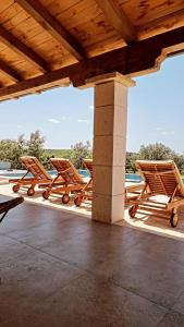 a group of chairs sitting on a patio at NEW 2023 Villa Tree of Life in Sveti Petar