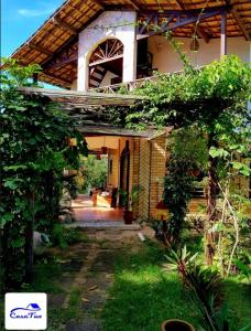 an outside view of a house with an archway at Casa Tua Pipa in Pipa