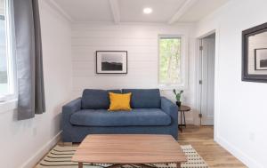 a blue couch in a living room with a table at Bonnie View Inn in Haliburton
