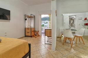 a room with a bed and a table and chairs at Hope apt - 5min to Falassarna Bch in Kissamos