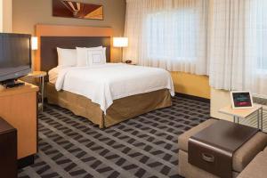 a hotel room with a bed and a flat screen tv at TownePlace Suites Old Mill District, Bend Near Mt Bachelor in Bend