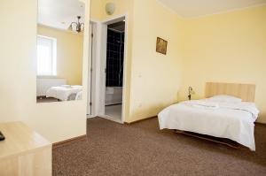 Postel nebo postele na pokoji v ubytování Hotel Tomas