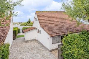 an aerial view of a white building with a roof at De Zeevijver Oostduinkerke in Oostduinkerke