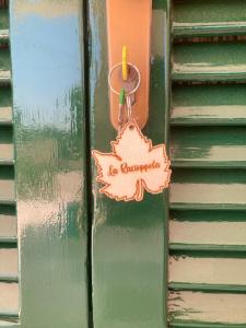 a door with a leaf on it on a house at La Racioppola in Ostuni