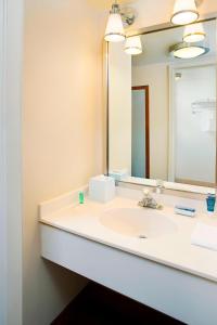 a bathroom with a sink and a mirror at Four Points by Sheraton Philadelphia Airport in Philadelphia