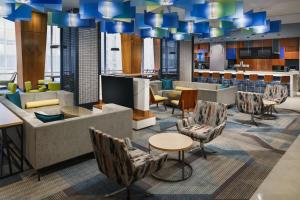 a large lobby with chairs and tables and a bar at Residence Inn New York Downtown Manhattan/Financial District in New York