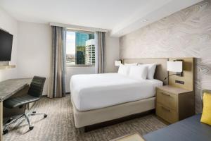 a hotel room with a bed and a desk and a computer at Residence Inn New York Downtown Manhattan/Financial District in New York