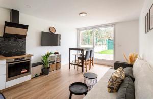 a living room with a couch and a table at Amazing flat, Paris suburb, near Versailles ,Orly in Orsay